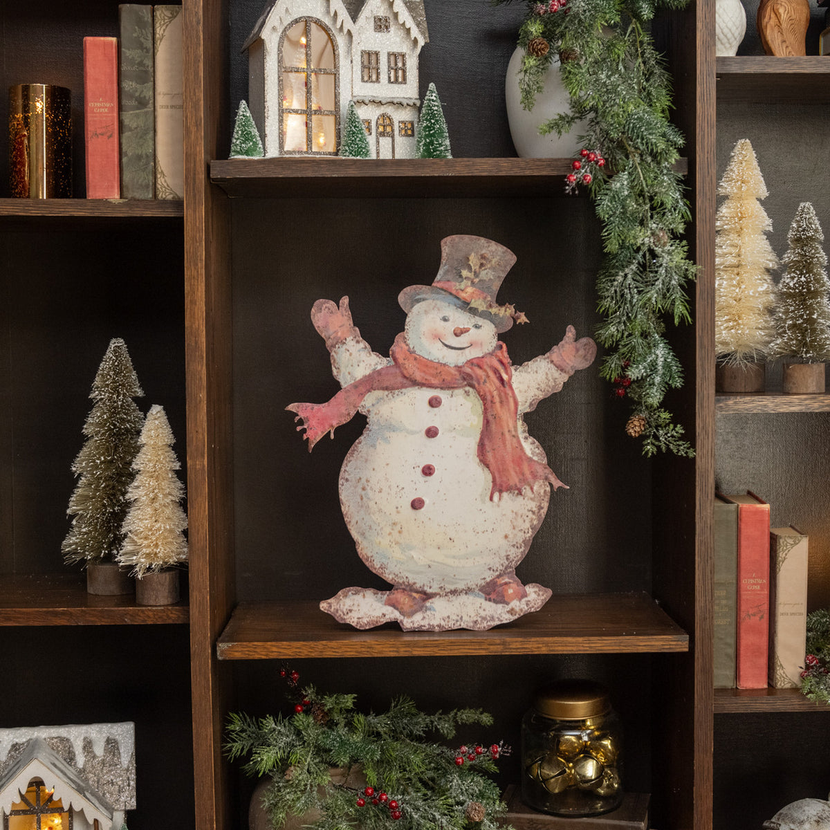 Metal dummy board shaped like a happy snowman with black eyes and carrot nose