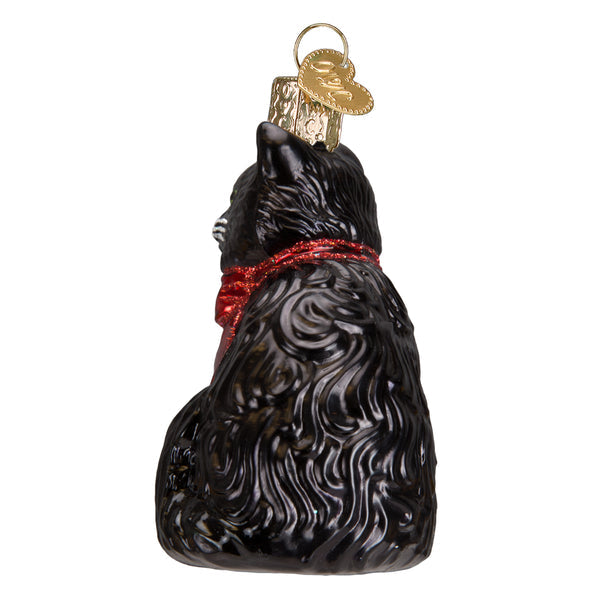 Back view of a black glass tuxedo cat ornament with a red glitter collar and gold hanging loop.
