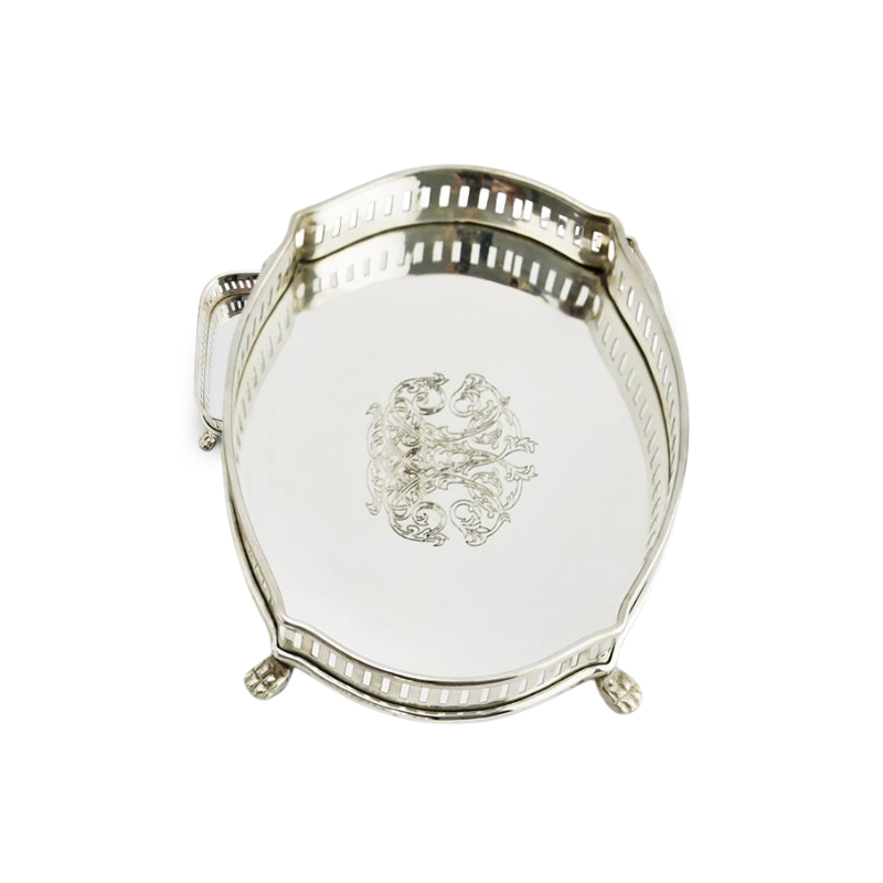 Oval silver-plated brass gallery tray with engraved center design and pierced gallery rim.