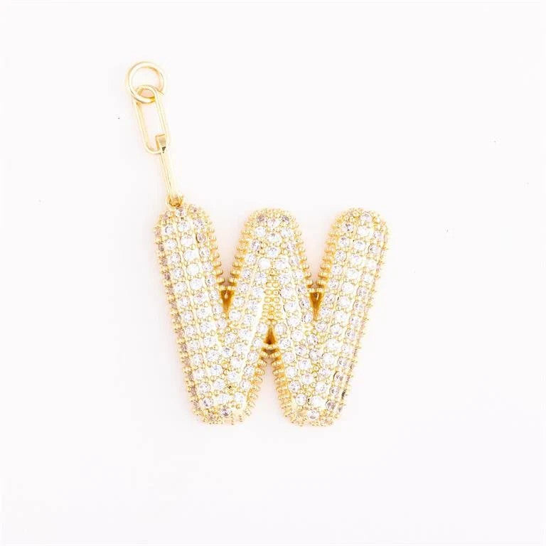 Heather-colored charm bag with 18k gold plating, pave crystal accents, and a customizable initial on an extender chain.