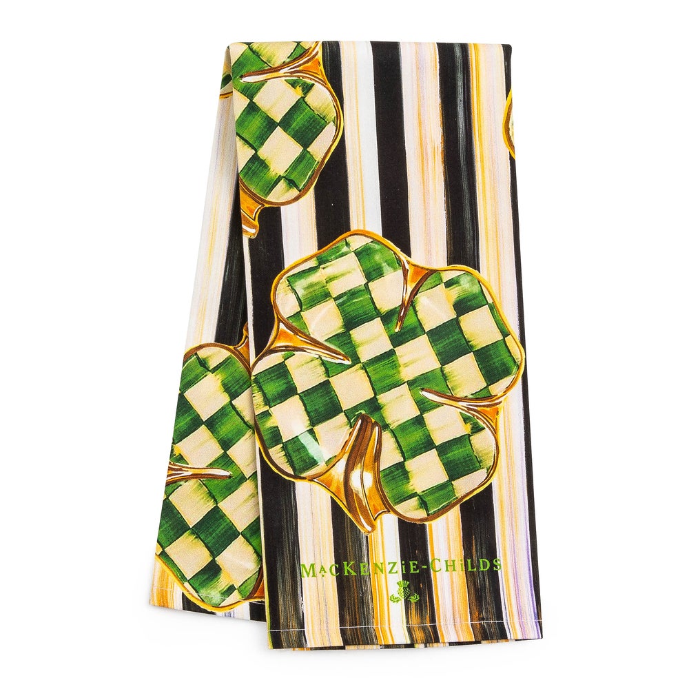 Dancing Clovers Dish Towel featuring green checkered clovers on a black and white striped background.