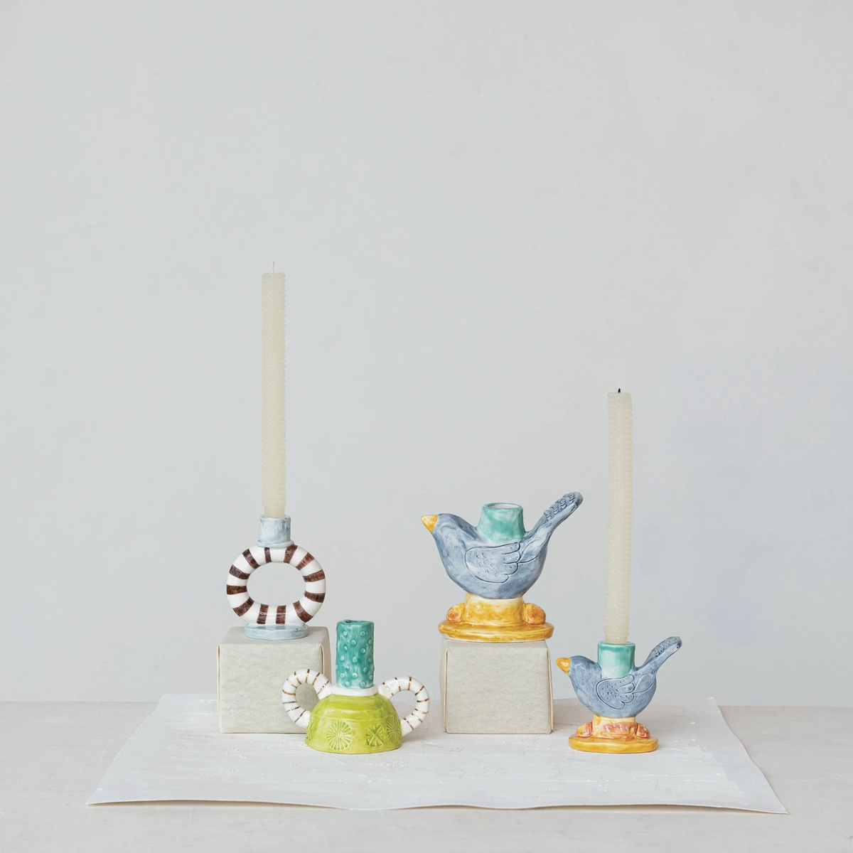 Reactive glaze stoneware taper holder shaped like a bird with organic silhouette