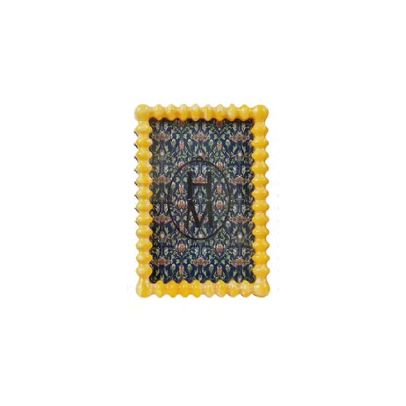 Yellow marbled resin frame with scalloped edges and a dark blue floral pattern insert.
