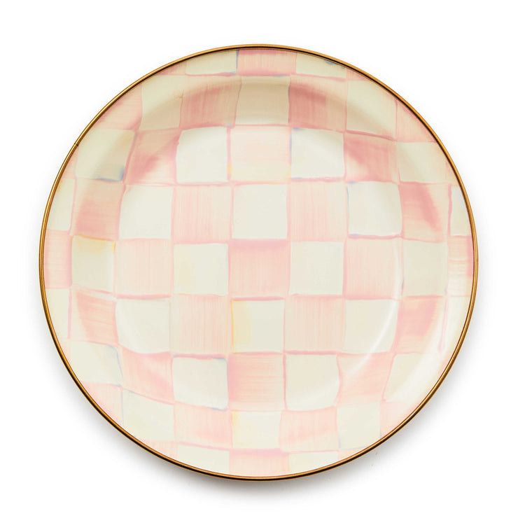 Top view of a round pie plate with a hand-painted pink and white checkered pattern and bronze rim.