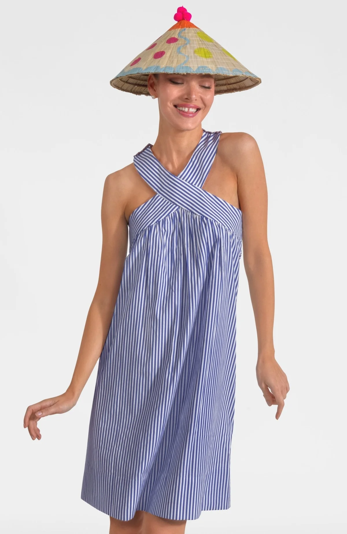 Woman wearing the Sandy Summer Sunshine Dress, a blue and white striped halter dress.