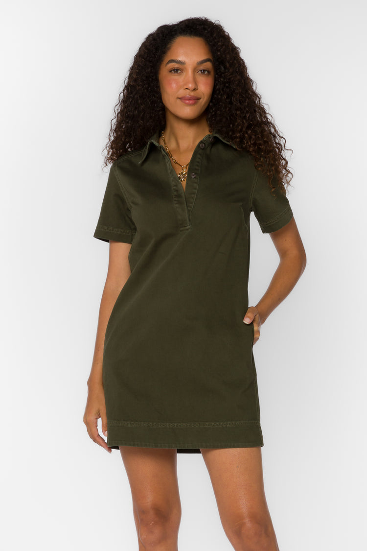 Woman wearing the Macayle Mini Dress in olive green with a split V-neckline and short sleeves.
