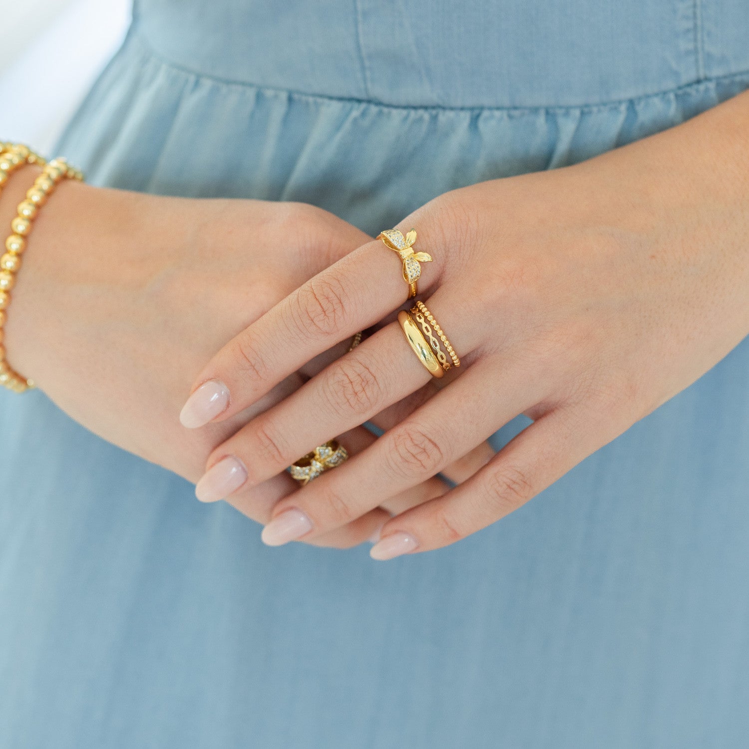 Adjustable pave bow ring in gold with cubic zirconia stones