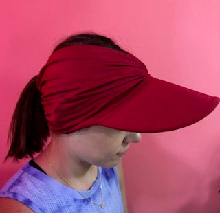 Women's bright colored open-top sun visor hat with wide brim and elasticized chinlon fabric.