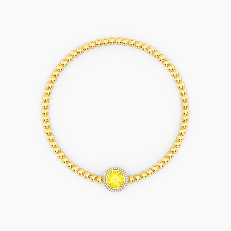 Gold plated beaded bracelet with a round yellow center stone and diamond halo.
