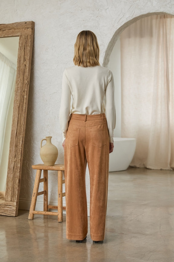 Back view of a woman wearing tan Lucy Faux Suede Wide Leg Pants and a white long-sleeve top.