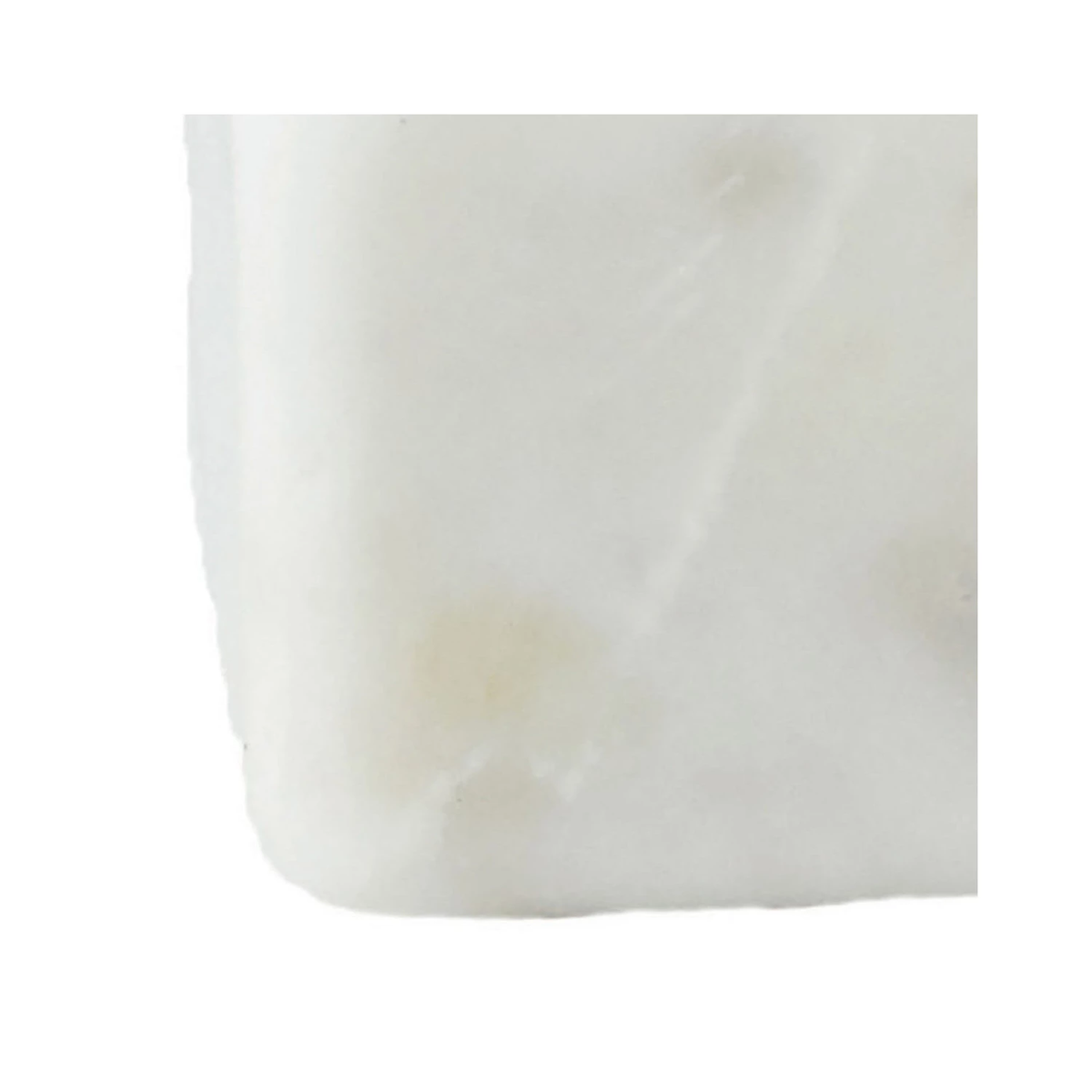Close-up detail of the smooth white marble texture on a square bowl.
