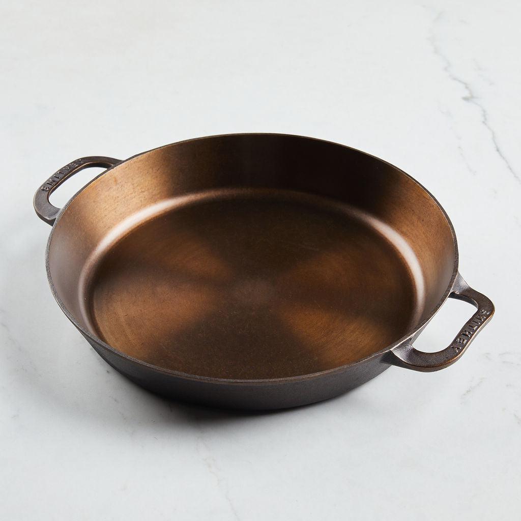 No. 14 Dual Handle Skillet with a polished finish and ergonomic helper handles on a marble surface.