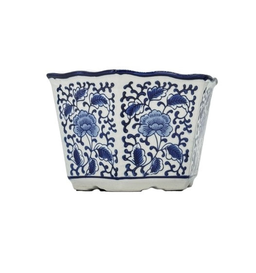 Ceramic plant pot with blue and white floral hexagon pattern featuring a ruffled lip rim.