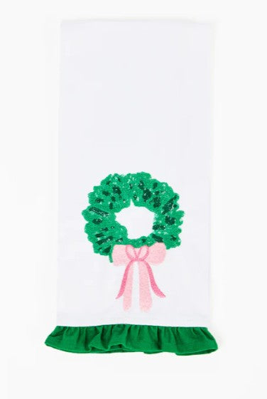Tea towel with sequin wreath embellishment, ruffle trim, and cotton fabric.