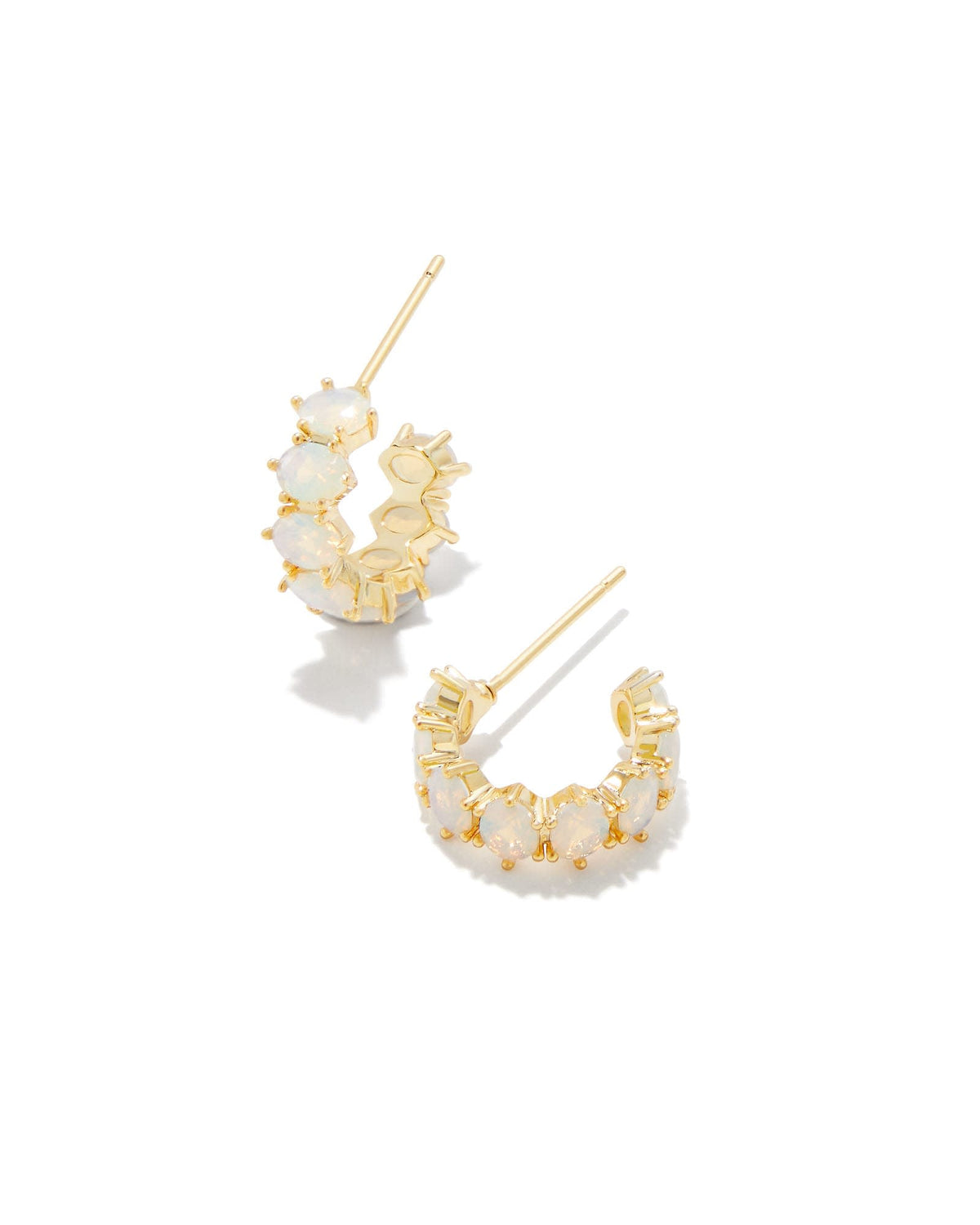 Silver huggie earrings featuring clear crystal accents on a polished earpost closure.
