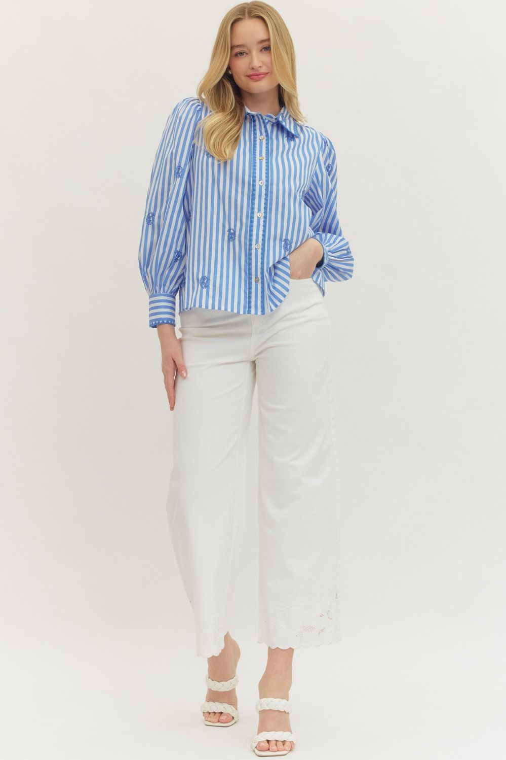 Woman wearing the Madeline Striped Long Sleeve Top with blue stripes and embroidered accents.