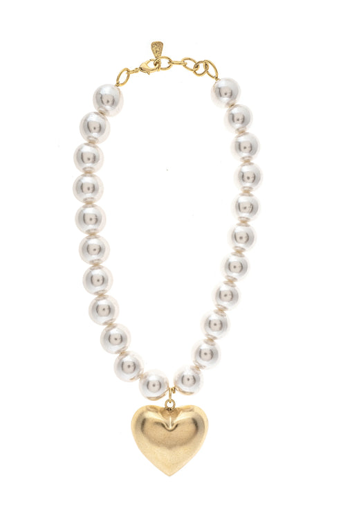 Hadassa Necklace featuring a strand of white pearl-like beads and a gold-tone heart pendant.