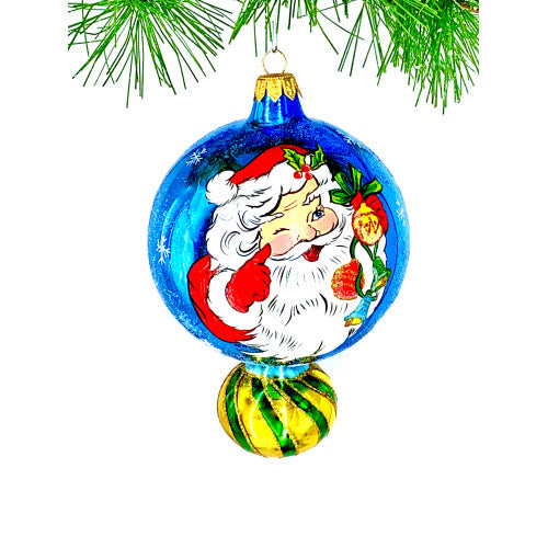 Blue glass Christmas ornament with Santa Claus design and a striped green and gold base.