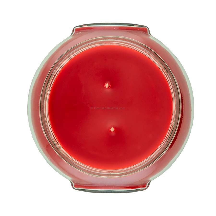 A large black jar candle with a white wick inside.