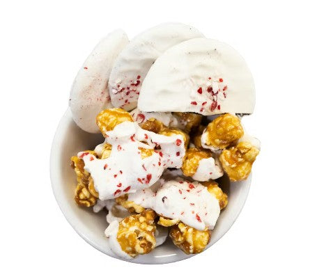 Christmas Cookie Crunch popcorn with caramel, white chocolate drizzle, and peppermint pieces.