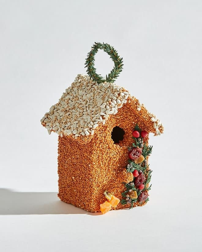 Hand-decorated wooden birdhouse cottage with millet, sunflower seeds, juniper, cranberries, and raisins.