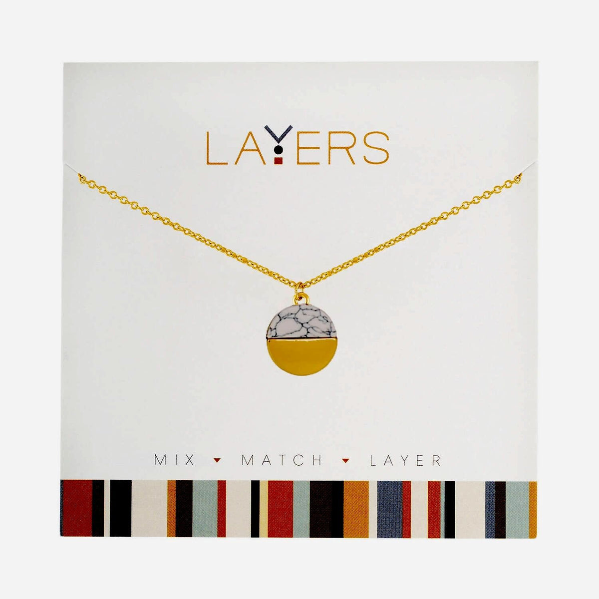 Gold circle pendant layered with granite stone accents on a chain necklace.