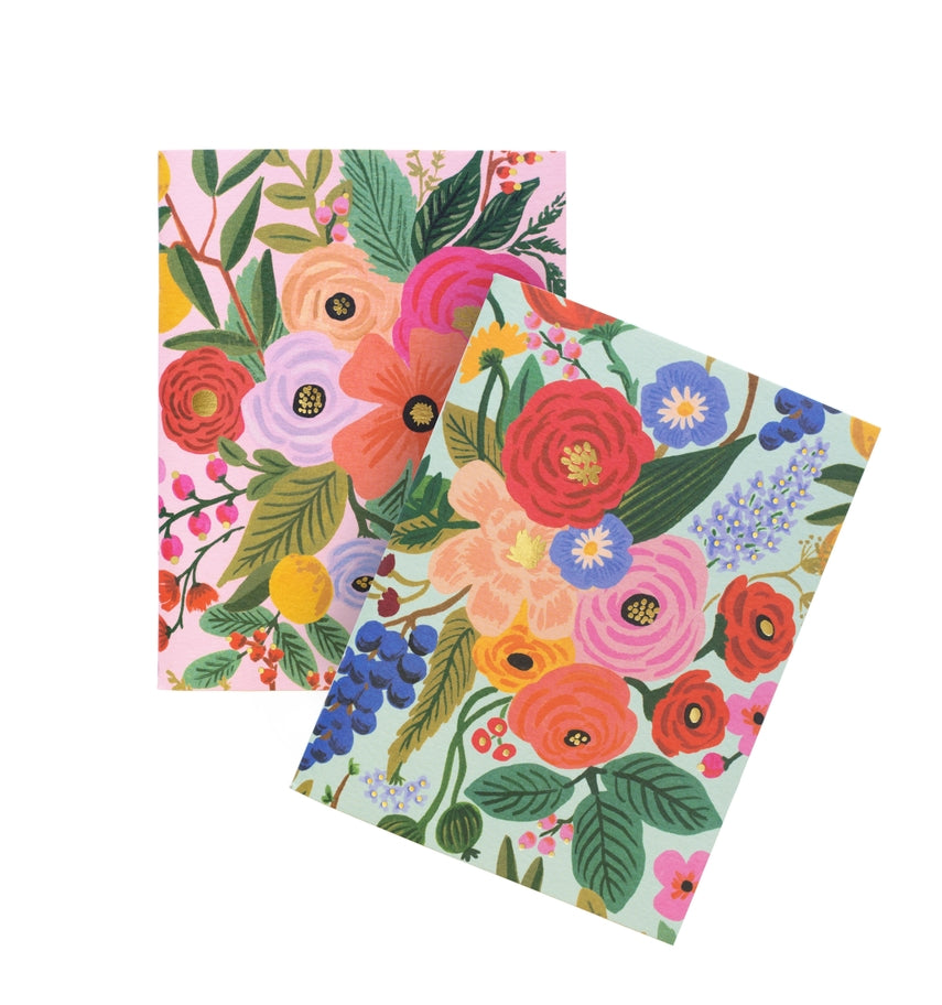 Pair of saddle-stitched pocket notebooks with uncoated natural vellum covers featuring metallic gold foil stamping.