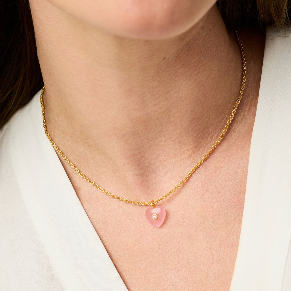 Delicate necklace featuring a pink quartz pendant with gold plating on an adjustable chain.