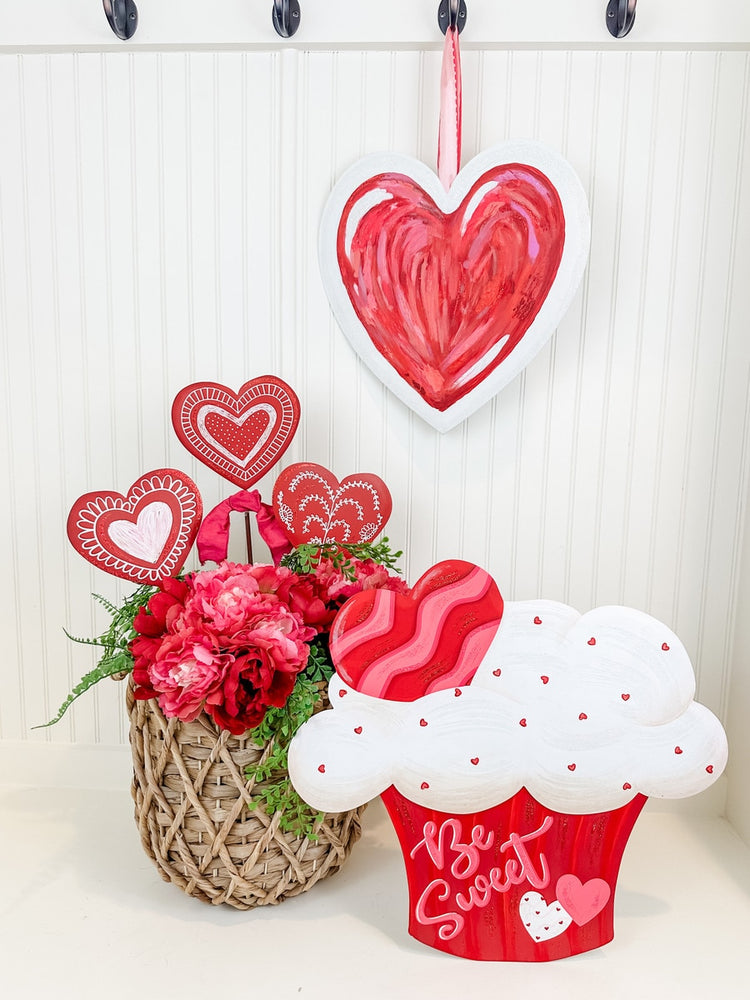 Red heart-shaped garden stake with a messy texture measuring 14 inches tall.