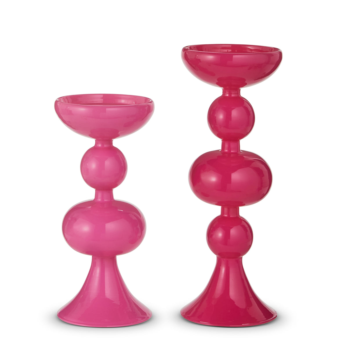 Pink glass candle holder with a tapered silhouette designed to hold taper candles.