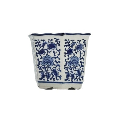 Blue and white hexagonal ceramic pot with ruffled lip edge featuring a floral pattern