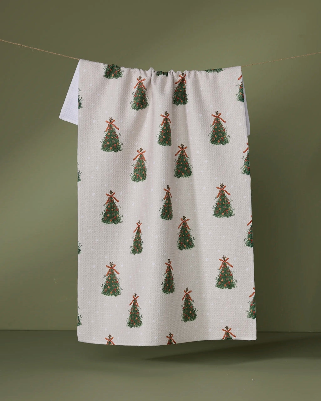 Holiday tea towel with waffle weave construction in red featuring a festive snowman pattern.