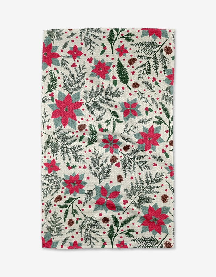 Holiday tea towel with waffle weave construction in red featuring a festive snowflake pattern.