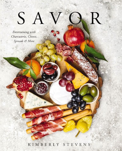 Book cover of Savor by Kimberly Stevens featuring a charcuterie board on a rustic wood slice.