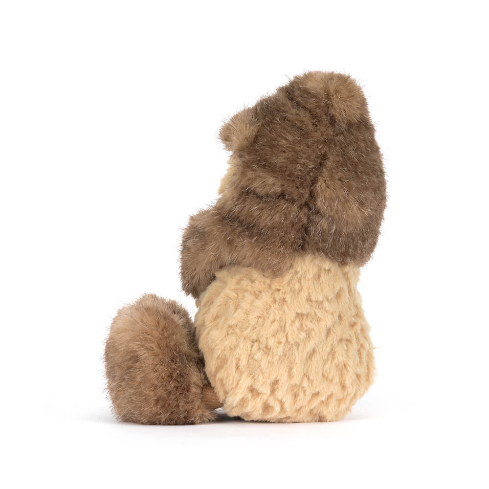 Back view of a plush peanut toy wearing a fuzzy brown and tan yeti costume.