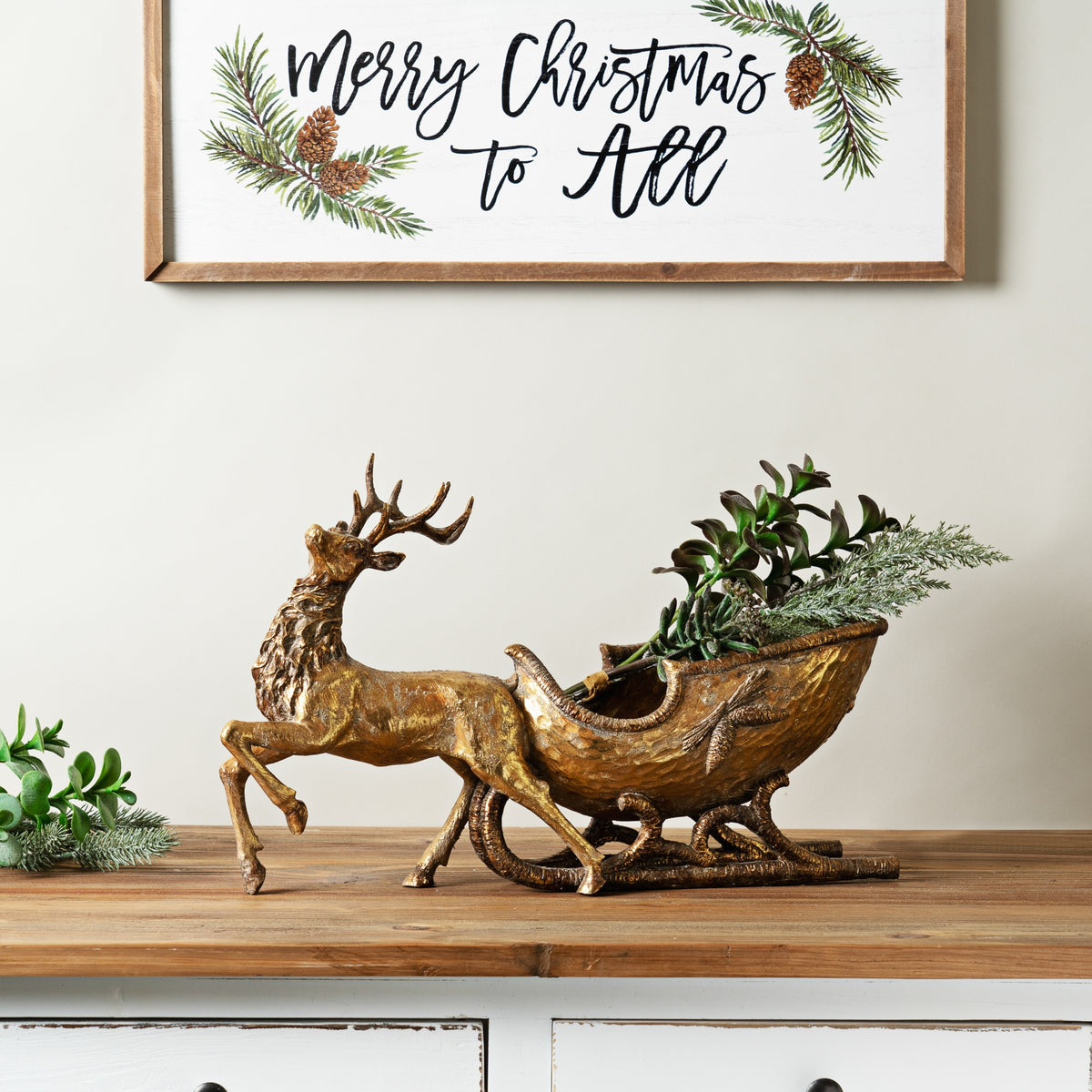 Hand-carved wooden deer figurine in natural finish with sleigh base