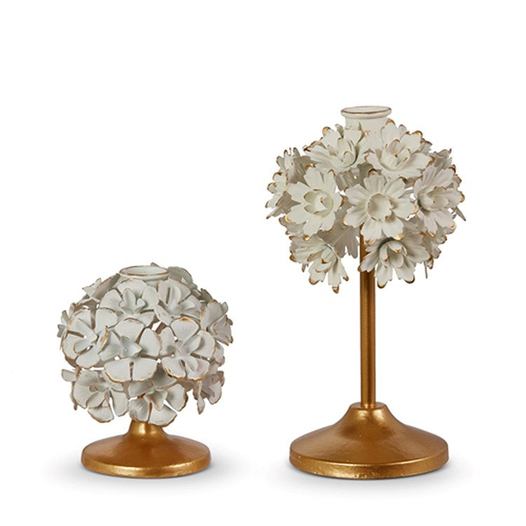 Cream-colored iron candle holder with a floral pattern.