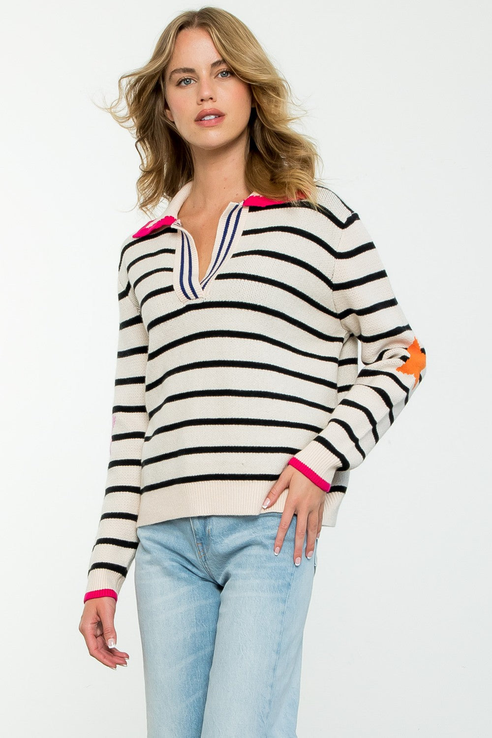 Woman wearing a navy blue striped knit sweater with a collar.