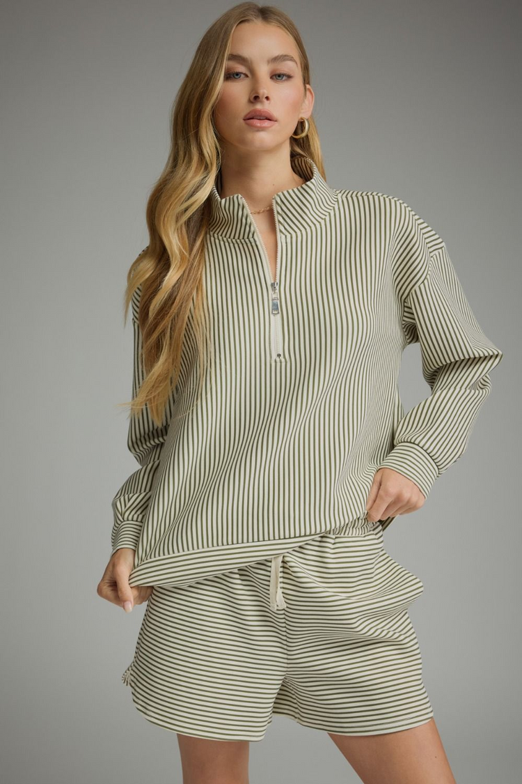 Woman wearing the Melissa Stripe Long Sleeve Knit Top with a quarter zipper and matching shorts.
