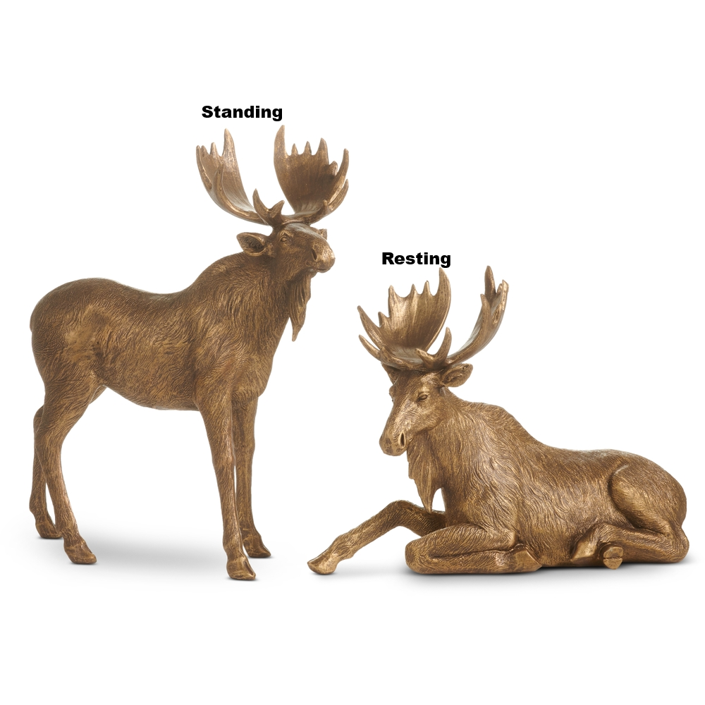 Two antique gold moose figurines in standing and resting poses with a rustic finish.