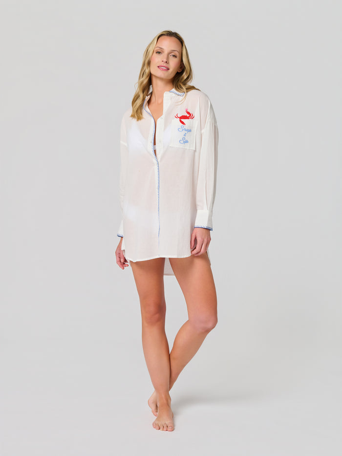 Relaxed fit cotton cover-up shirt with rolled cuffs, red crab embroidery, ocean-blue stitching, and a coastal design.