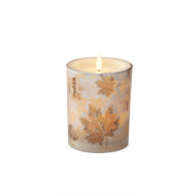 Large frosted glass LED candle with gold maple leaf patterns and a warm glowing flameless wick.