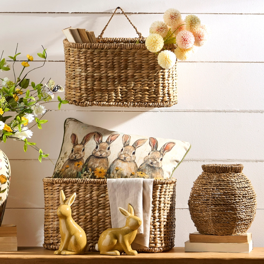 Small woven water hyacinth basket with a sturdy handle in natural beige tones.