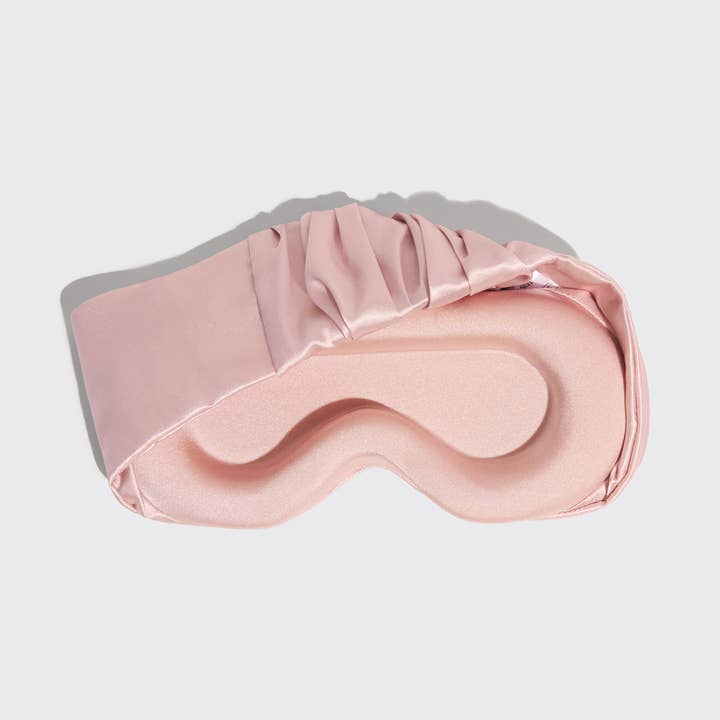 Blush satin eye mask with ruched elastic band blocking light