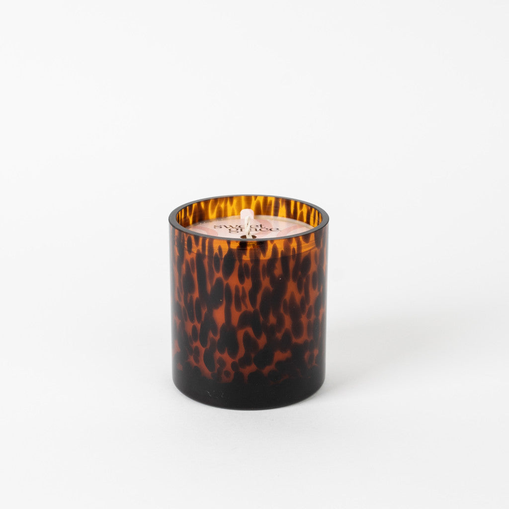 Soy-blend Sweet Grace candle in a clear glass vessel with white wax.