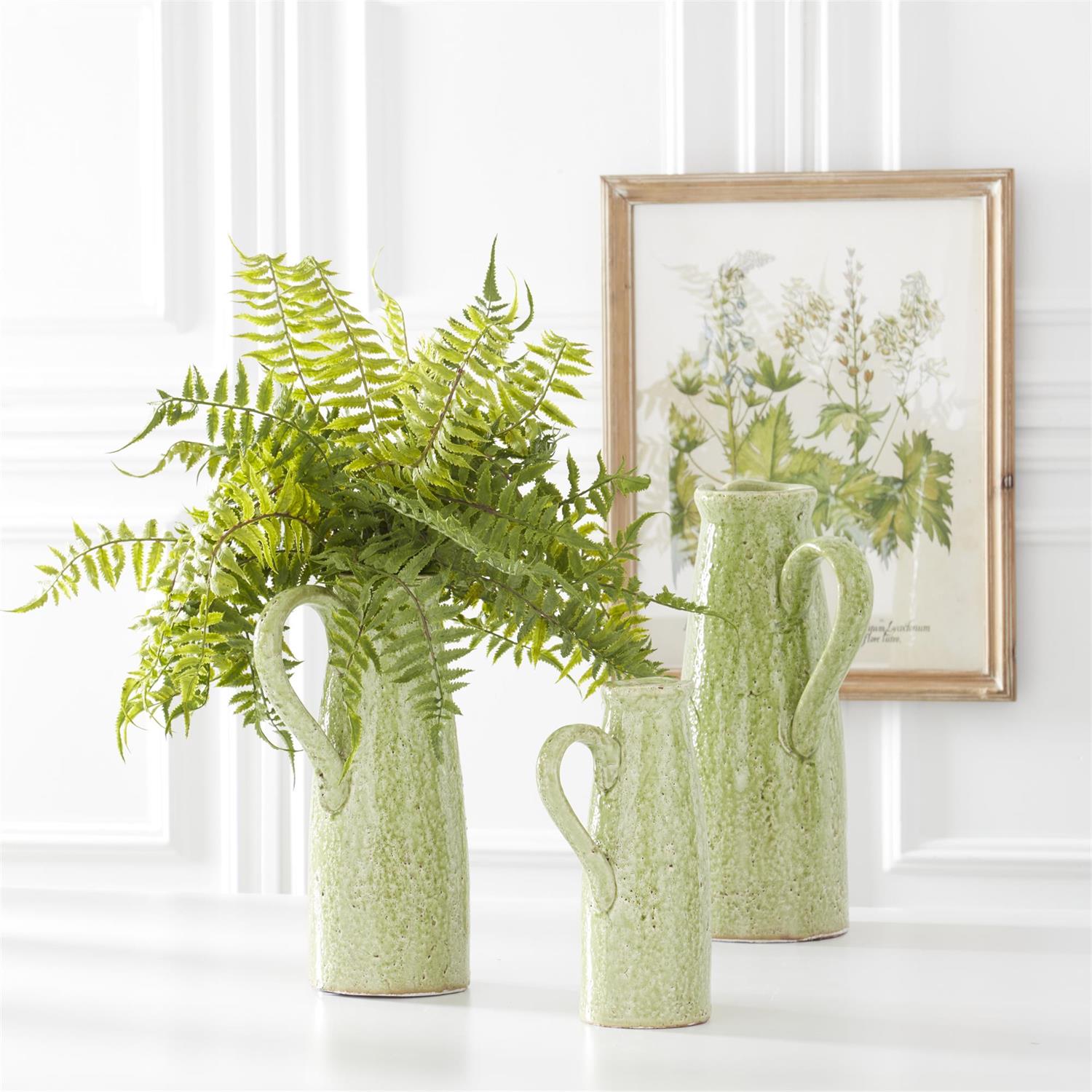 Terracotta green ceramic pitcher with a crackled glaze finish.