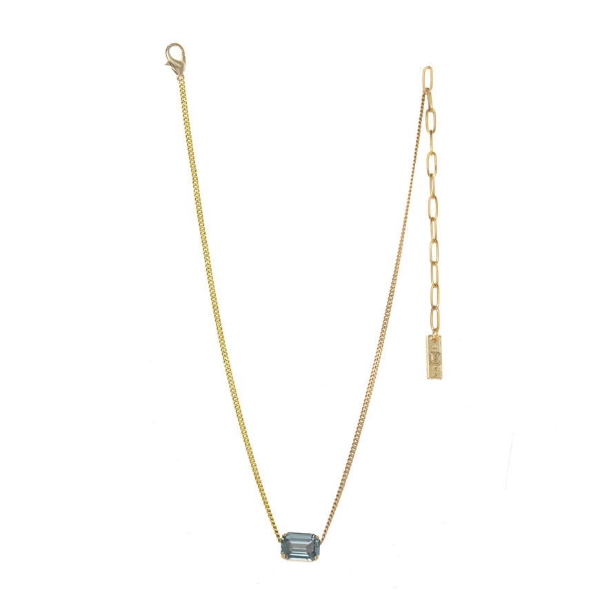 Gold chain necklace with a rectangular blue crystal pendant and adjustable extender.