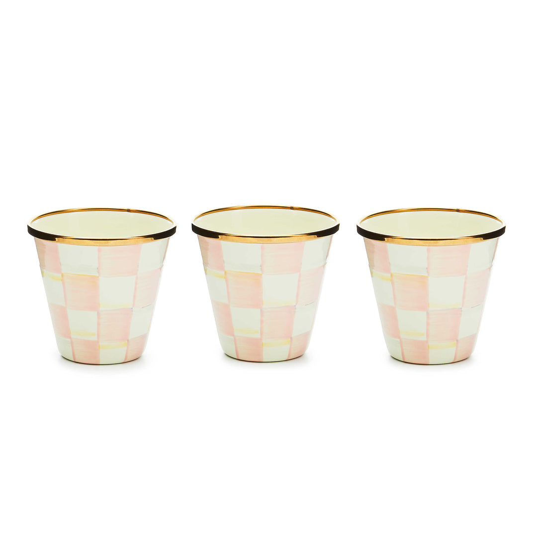 Three hand-painted pink and white checkered herb pots with bronzed stainless steel rims.