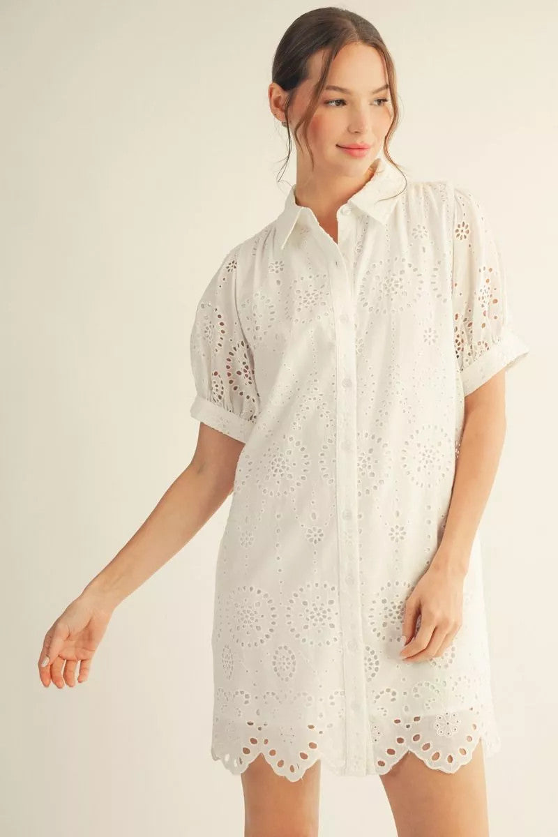White cotton short sleeve button down dress with scallop hem and wide pockets.