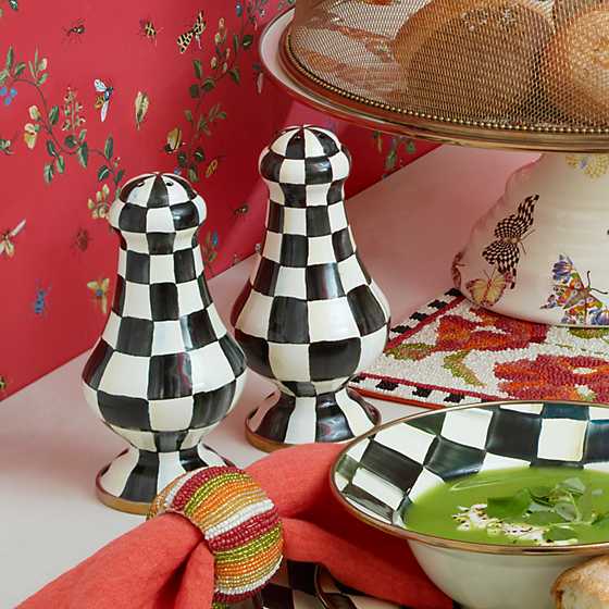 Large Courtly Check enamel salt shaker with hand-painted pattern on steel body and bronzed stainless rim.